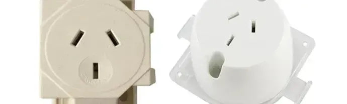 Cream and white circular downlight plug bases with three pin sockets and square mounting flanges