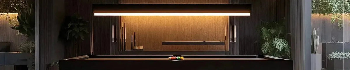 Sleek black linear pendant light suspended above a modern pool table in a dark timber panelled games room