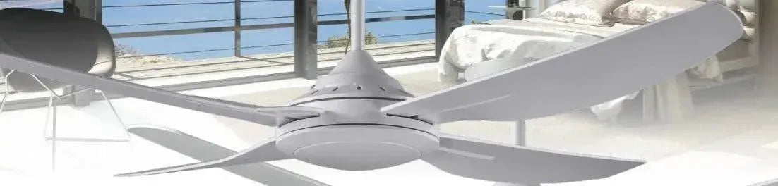 Modern matte white ceiling fan with four curved blades installed in a bright bedroom overlooking a balcony