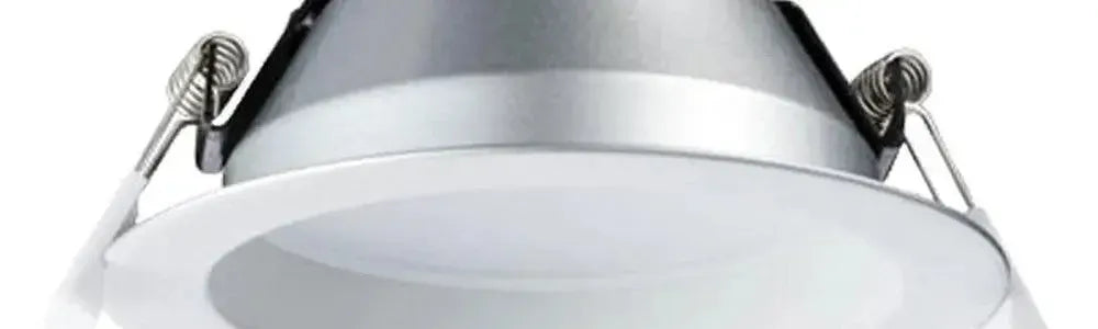 Round white recessed downlight with a silver metallic housing and spring mounting clips