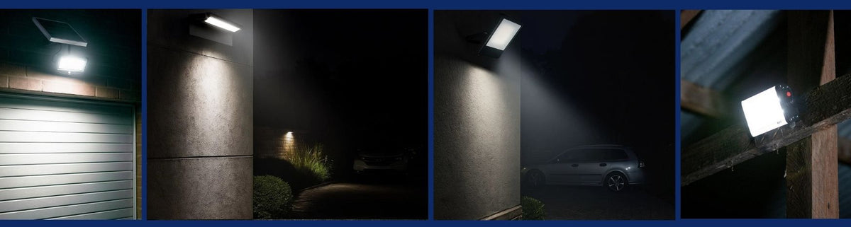 Black rectangular solar flood lights mounted on exterior walls and timber beams casting bright beams at night