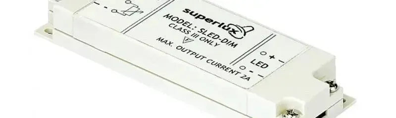 Rectangular white plastic LED strip dimmer with screw mounting tabs and clear terminal labels on a white background