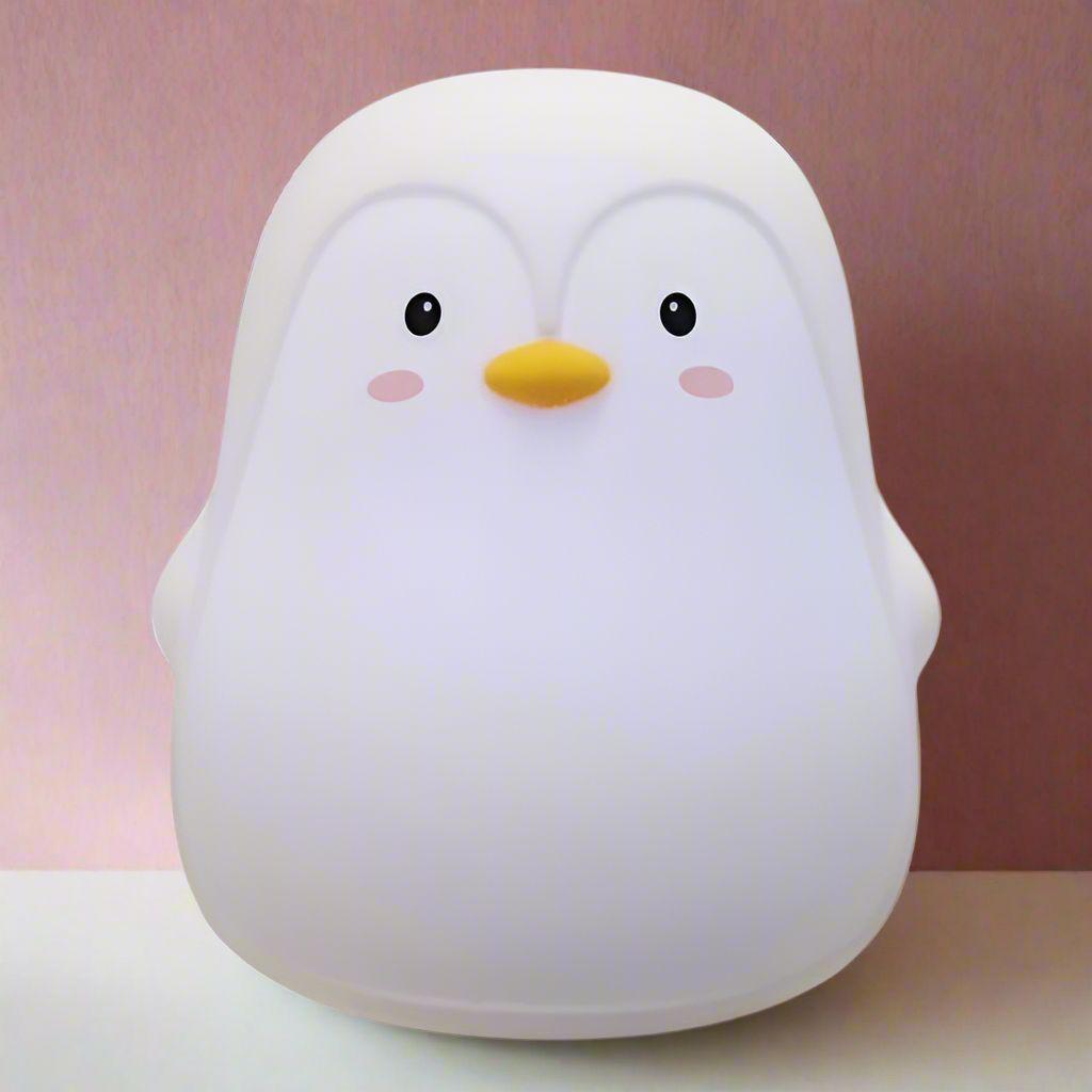 Amya white penguin-shaped LED night light made from soft, touchable silicone for children's bedrooms.